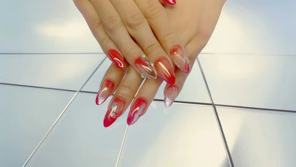 Custom red stiletto nails with artistic details
